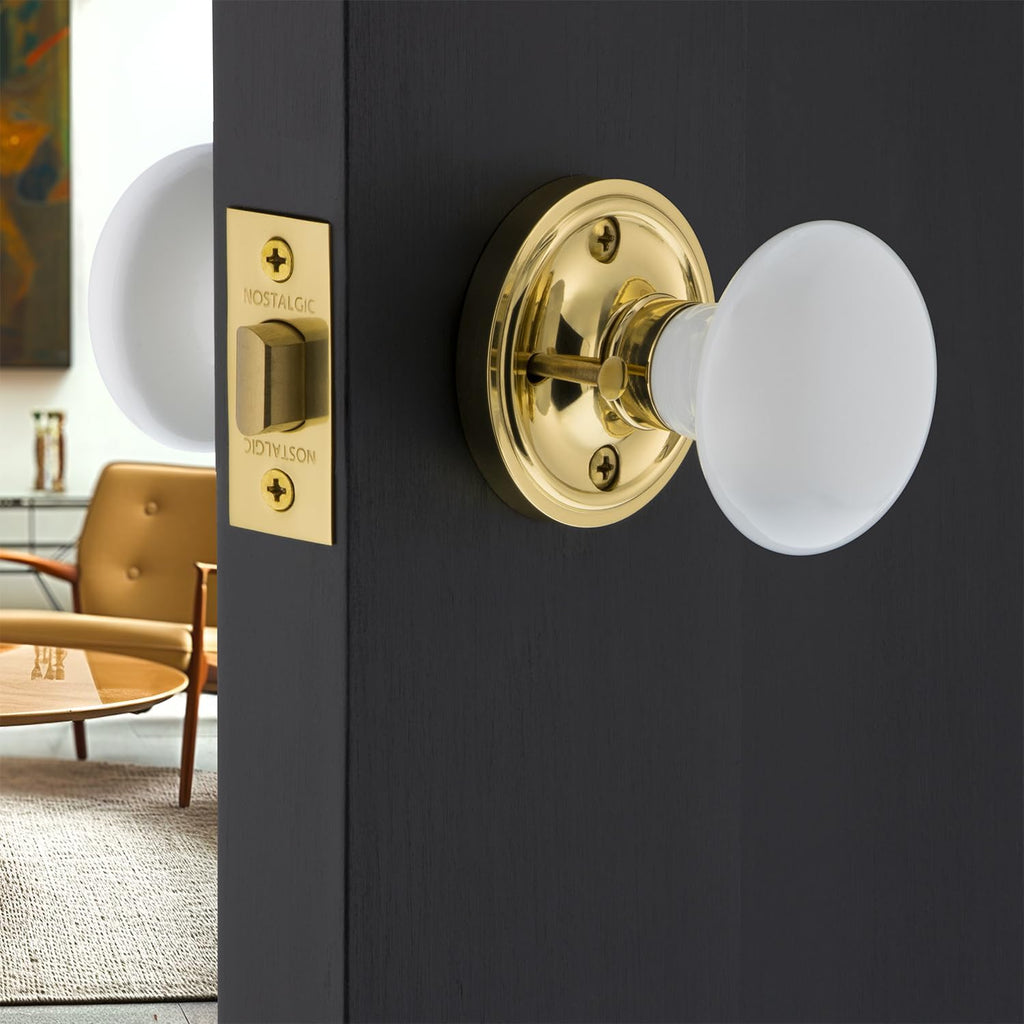 Classic Rosette Privacy White Porcelain Door Knob in Unlacquered Brass