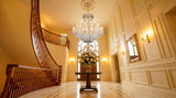Gold Maria Theresa Empress crystal chandelier in grand two-story foyer with staircase