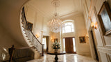 Silver Maria Theresa Empress crystal chandelier in grand foyer with curved staircase